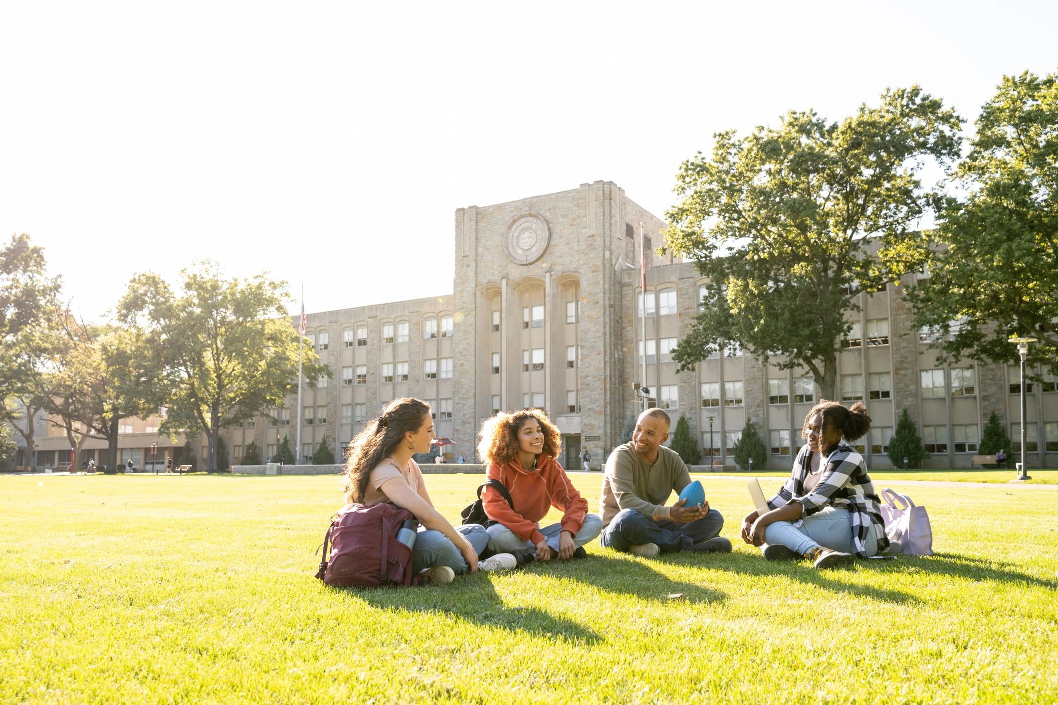 University students gathered on a campus lawn